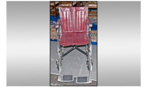 Carters Collapsible push along Wheelchair, maroon in colour with larger rear wheels.