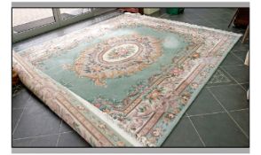 Large Room Size Wool Rug. Pink decoration on predominantly light green ground. Fringed edges. 12