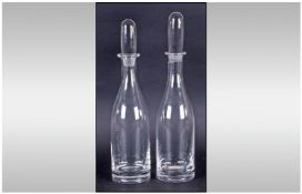 A Fine Pair Of Hand Made Bottle Shaped Clear And Plain Glass Decanters. Possibly Whitefriars. Each