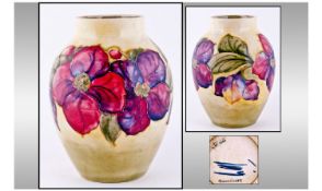 William Moorcroft Bulbous Shaped Vase, "Anemone" range on yellow and green ground. Good condition.