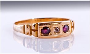 Ladies Early 20th Century Diamond And Garnet Dress Ring, Set with central diamond Between 2 Garnets,