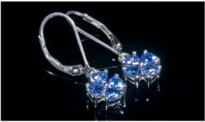 Pair of Tanzanite Drop Earrings, each cluster drop comprising 4 trillion cut tanzanites, trillion