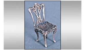 Dutch Fine 19th Century Silver Miniature Ornate Chair, embossed cherubs to seat. 2.25" in height.