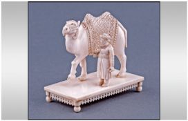 Indian Ivory Figure Of A Robed Camel With Figure, raised on a footed platform. Circa 1900's.