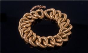 High Carat Gold Fancy Link Bracelet, circular concave links with chased scroll and floral front.