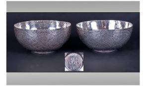 A Pair Of Nigerian Silver Bowls. Decorated with traditional knot work throughout. Marked "Aikena