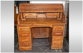An Oak Roll Top Desk, with fitted interior, supplied by Simpole's Office Furnishers, Manchester.