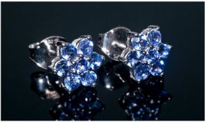 Pair of Tanzanite Floral Stud Earrings, each cluster comprising seven round cut tanzanites in a