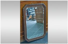 Carved Oak Framed Mirror. Canted Corners, bevelled glass. 34 by 23 inches.