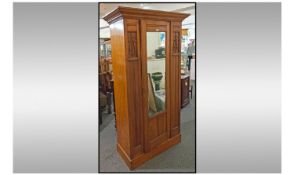 Art Nouveau Single Wardrobe, mirrored door, panelled front, with pierced motifs. Height 80 inches,