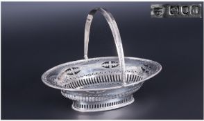 A Fine Victorian Swing Handle Silver Sweet Meat Basket. With pierced decoration on an oval body with