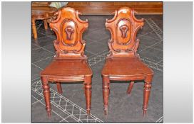 Pair Of Victorian Carved Hall Chairs, typical shaped back with turned front and sabre back legs.