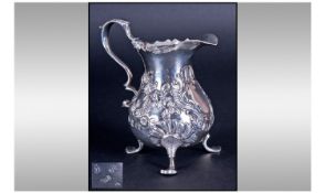 George II Silver Baluster Cream Jug. By Charles Chesterman I, on three splayed feet with a wavy