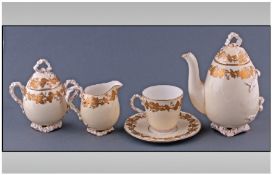 Gilt Ivy Leaf Bachelor Tea Set, comprising pale yellow ovoid tea pot, lidded sugar bowl and milk