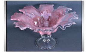 A Large Murano Petal Shaped Footed Bowl. Pink in colour with a clear glass pedestal base. Diameter