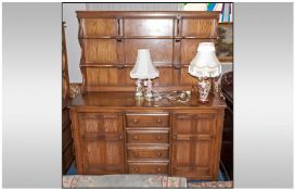 Ercol Dresser And Rack, 2 shelf rack above a base unit with four central draws between two