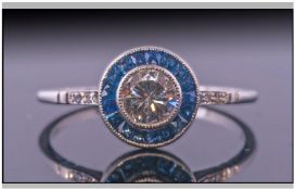 18ct Gold Art Deco Sapphire And Diamond Ring. Set with a central round modern brilliant cut diamond,