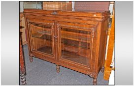 Mahogany Sideboard, two glazed doors with carved feet and embellishment. 42 inches high, 54 wide and