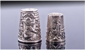 Two Silver Thimbles. The larger embossed with an amusing duck wearing a hat against a waffle and