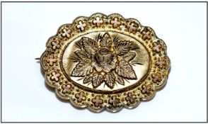 9ct Gold Pressed Brooch Of Shaped Form, with Floral Centre. 9ct Tab. 24 x 31mm.