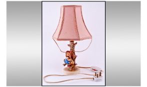 Hummel Figural Table Lamp. Girl on a branch. Early piece. Stands 15.5 inches high. Includes shade.