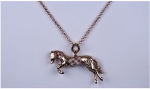 9ct Gold And Diamond Set Reticulated Horse Pendant, with horse shoe catch. Fitted on a 9ct gold