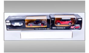 Two Unopened Rastar Model Cars In Original Boxes. 1, Porche 911 GT3 RS, with remote. 2, Mini Cooper