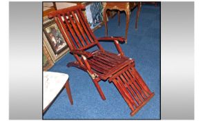 A Reproduction Teak Steamer Chair, with brass fittings, slatted backs and seats with adjustable