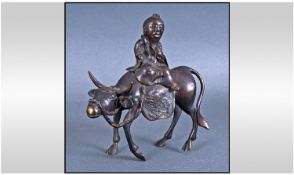 A Small Chinese Bronze Figure Of An Old Man Riding A Water Buffalo. Height 6.25 inches.