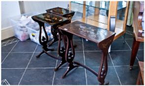 Nest of Four Lacquered Tables, gilt dragon decoration, patterned edge, with scrolled supports to