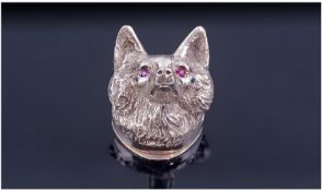 A Silver Pill Box, designed as the head of a fox with red gem set eyes. The neck opens to reveal