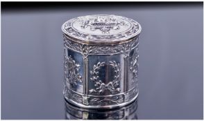 An Italian Silver Cylindrical Box. The hinged lid and sides decorated in fine relief with panels of