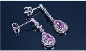 9ct White Gold Drop Earrings. Set with a Pear Shaped Pink Sapphire and Diamond Chips.