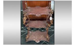 A French Antique Cast And Moulded Iron Three Tier Eti Je Stand, with shaped shelves with interior