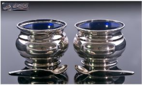 A Pair Of Silver Salts And Salt Spoons. The baluster shaped salts with blue glass liners. The salts