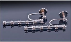 18ct White Gold Set Diamond Drop Earrings. Each earring set with 6 diamond spacers. Marked 18ct.