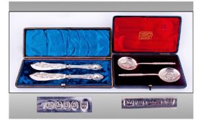 Edwardian Boxed Pair Of Ornate Silver Handle Butter Knives. Length 6.75 inches. Unused. Plus a box