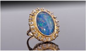 18ct Gold Opal Ring. Large Central Black Oval Opal Triplet (Approximately 17 x 12mm) Surrounded By