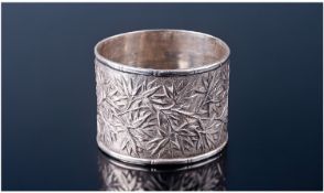 A Handsome Chinese Silver Napkin Ring. Decorated overall in relief with leafy Bamboo. Unmarked but