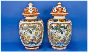 Chinese Pair Of Mid 20th Century Decorative Lidded Vases, with character marks to base. Each stands