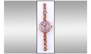 Ladies 9ct Gold Cased Rolex Wrist Watch. Shaped 27mm Engraved case. Silvered Dial with Arabic