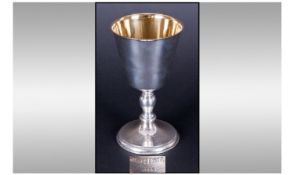A.E Jones. A fine silver and silver gilt goblet with knopped stem and spreading foot. Hallmarked