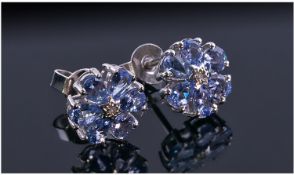 Tanzanite and Diamond Flower Cluster Earrings, each earring having six pear cut stones centred by a