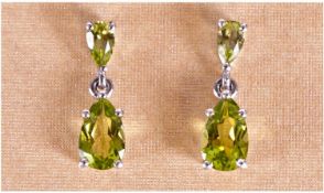 Pair of Peridot Drop Earrings, pear cut Chinese peridots suspended from smaller, inverted, pear cut