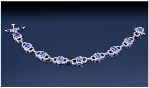 Tanzanite Art Deco Style Bracelet comprising nine cushion cut tanzanites, each over .5 ct, within