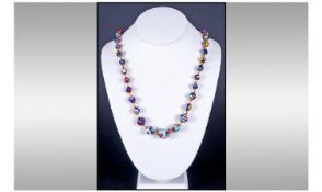 Italian Millefiori Style Necklace. Comprising Graduating Glass Beads with Amber Coloured Spacers.