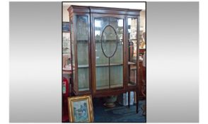 Edwardian Mahogany astral glazed cabinet with a central door. Flanked by 2 small glazed panels /