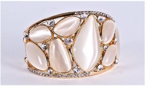 White `Cat`s Eye` and Crystal Cuff Bangle, randomly shaped white `cat`s eye` effect stones