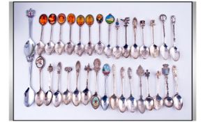 Tin Containing A Collection Of Silver Plated Souvenir Spoons.