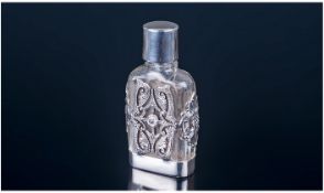 A Silver and Glass Scent Bottle with Silver Screw Cap Silver Base and Sides Set with Marcasite